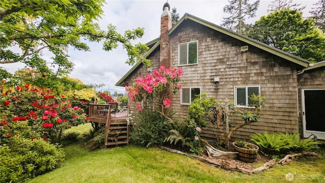 2904 271st St, Ocean Park, WA 98640 - rear view of property featuring a deck, a chimney, and a lawn