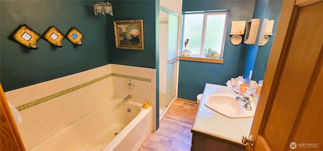 2904 271st St, Ocean Park, WA 98640 - bathroom with wood finished floors, a garden tub, vanity, and a stall shower