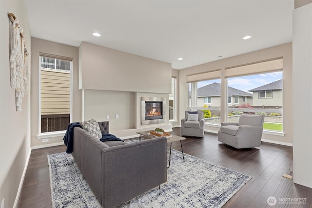 13506 196th Ave SE, Monroe, WA 98272 - living room featuring dark wood-style flooring, a glass covered fireplace, and recessed lighting