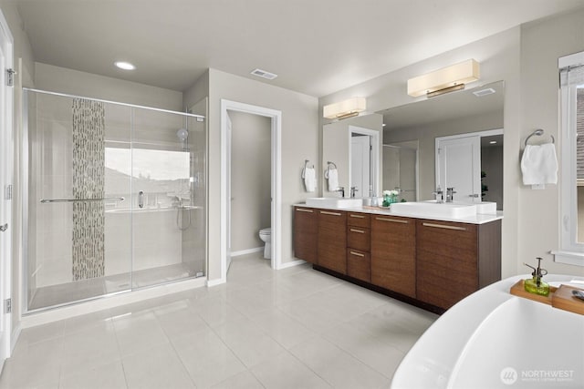 13506 196th Ave SE, Monroe, WA 98272 - bathroom featuring double vanity, a shower stall, a freestanding bath, and tile patterned floors