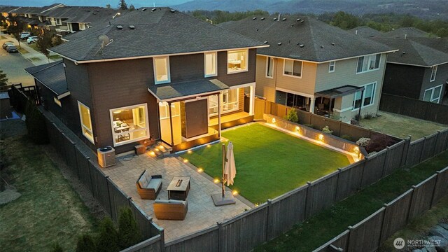 13506 196th Ave SE, Monroe, WA 98272 - rear view of house with a fenced backyard, a shingled roof, and a patio area