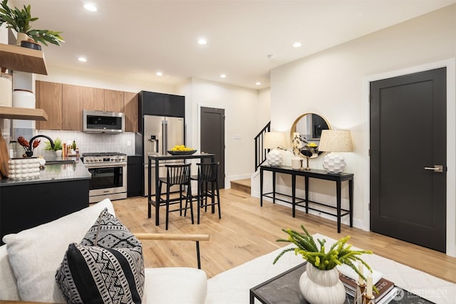 9047 Dibble Ave NW Unit C, Seattle, WA 98117 - living room featuring stairway, recessed lighting, and light wood-style flooring