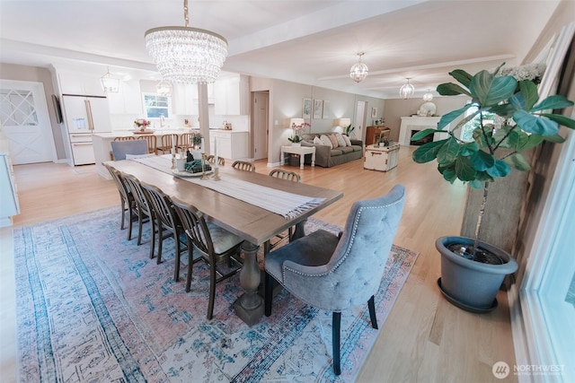 1325 SW 120th St, Burien, WA 98146 - dining room featuring a chandelier, light wood-style floors, and a fireplace