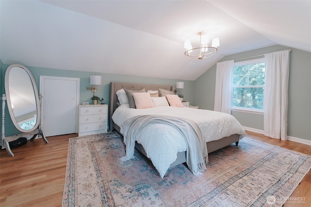 1325 SW 120th St, Burien, WA 98146 - bedroom with vaulted ceiling, light wood-style flooring, and a chandelier