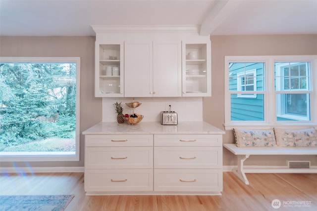1325 SW 120th St, Burien, WA 98146 - kitchen with light wood-style floors, glass insert cabinets, white cabinetry, and plenty of natural light