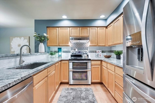 2001 120th Pl SE Unit 3-104, Everett, WA 98208 - kitchen with stainless steel appliances, under cabinet range hood, light wood finished floors, light stone counters, and light brown cabinets