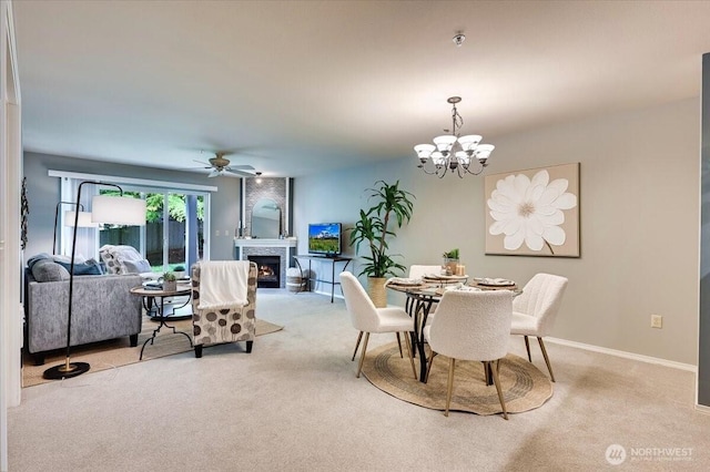 2001 120th Pl SE Unit 3-104, Everett, WA 98208 - dining area featuring light carpet, ceiling fan, a lit fireplace, and a chandelier