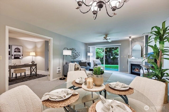 2001 120th Pl SE Unit 3-104, Everett, WA 98208 - dining room featuring carpet flooring, a chandelier, a glass covered fireplace, and ceiling fan