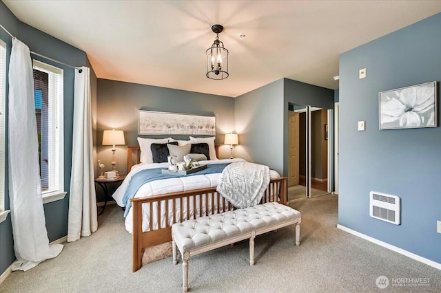 2001 120th Pl SE Unit 3-104, Everett, WA 98208 - bedroom with light carpet, heating unit, and a chandelier