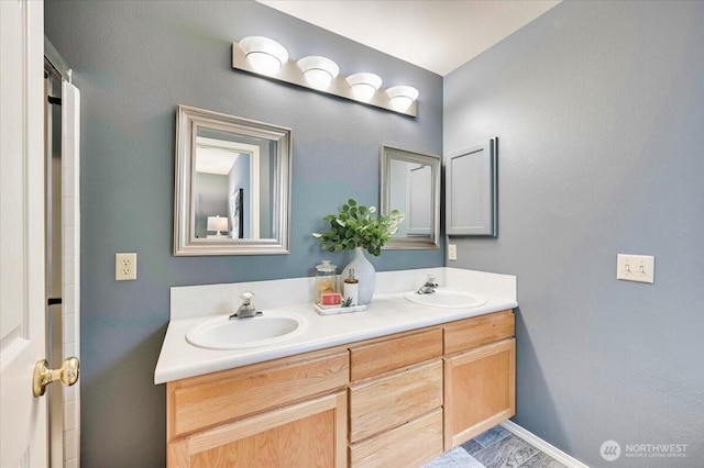 2001 120th Pl SE Unit 3-104, Everett, WA 98208 - bathroom with double vanity and baseboards