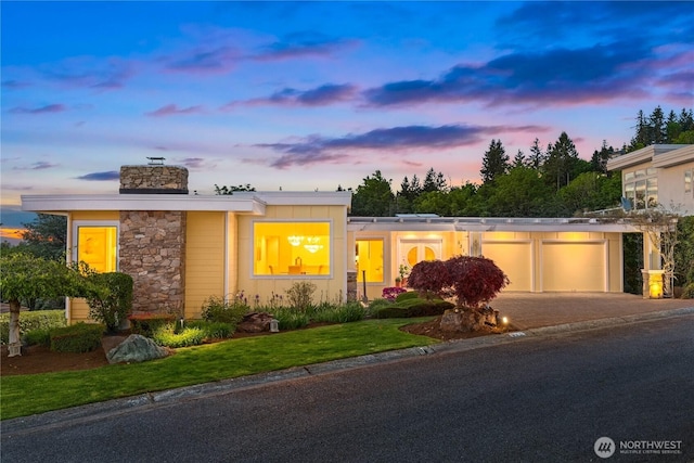 5310 143rd Ave SE, Bellevue, WA 98006 - mid-century modern home with a garage, stone siding, driveway, and a chimney