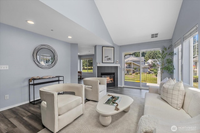 4714 Fairwood Blvd NE Unit 1301, Tacoma, WA 98422 - living area featuring dark wood-style floors, lofted ceiling, healthy amount of natural light, a tiled fireplace, and recessed lighting
