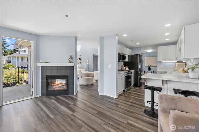 4714 Fairwood Blvd NE Unit 1301, Tacoma, WA 98422 - kitchen featuring stainless steel appliances, open floor plan, dark wood-style floors, white cabinetry, and light countertops