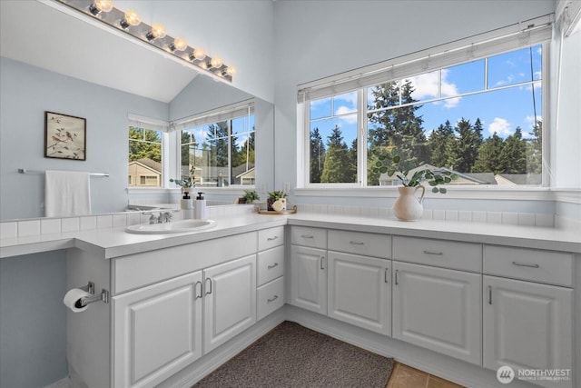 4714 Fairwood Blvd NE Unit 1301, Tacoma, WA 98422 - bathroom with healthy amount of natural light, vanity, vaulted ceiling, and tile patterned flooring