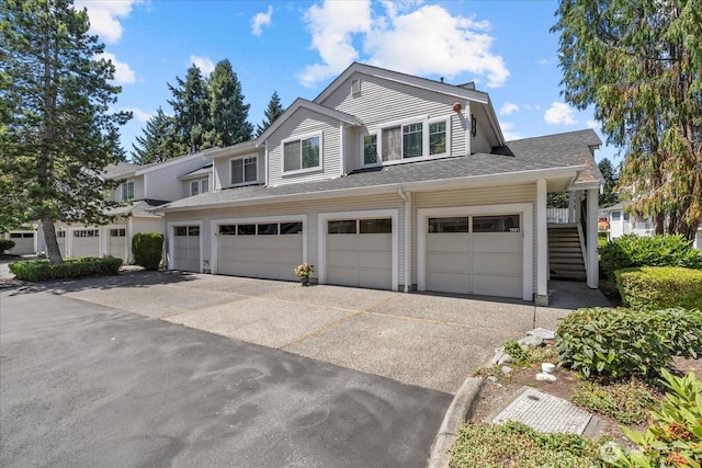 4714 Fairwood Blvd NE Unit 1301, Tacoma, WA 98422 - view of front of house featuring a garage, driveway, stairs, and a shingled roof