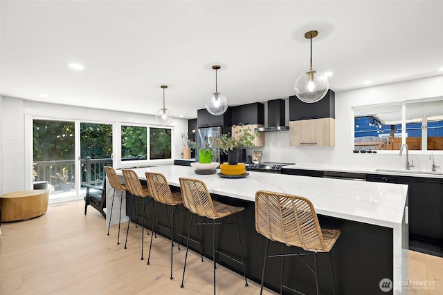 11171 SE 59th St, Bellevue, WA 98006 - kitchen featuring wall chimney range hood, dark cabinetry, tasteful backsplash, a spacious island, and recessed lighting