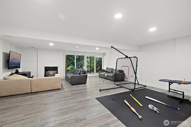 11171 SE 59th St, Bellevue, WA 98006 - workout area with recessed lighting, a multi sided fireplace, and wood finished floors