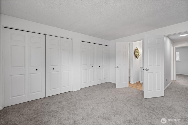 4036 Debbie Ct SE, Olympia, WA 98501 - unfurnished bedroom with carpet floors, two closets, and a textured ceiling