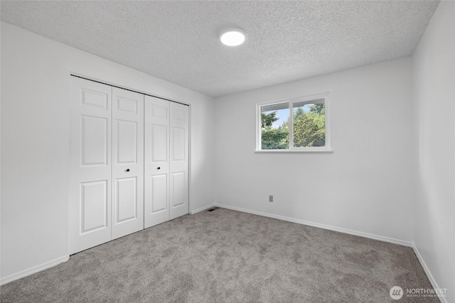 4036 Debbie Ct SE, Olympia, WA 98501 - unfurnished bedroom with a textured ceiling, carpet flooring, and a closet