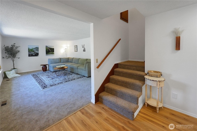 4036 Debbie Ct SE, Olympia, WA 98501 - staircase featuring wood finished floors and a textured ceiling