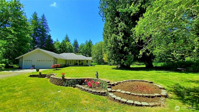 1225 98th Ln SE, Olympia, WA 98501 - view of grassy yard with an attached garage and driveway