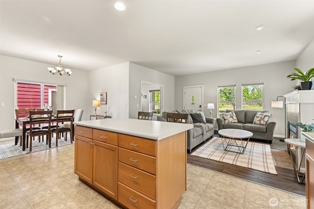 5611 Balustrade Blvd SE, Lacey, WA 98513 - kitchen with a chandelier, a kitchen island, light countertops, recessed lighting, and decorative light fixtures