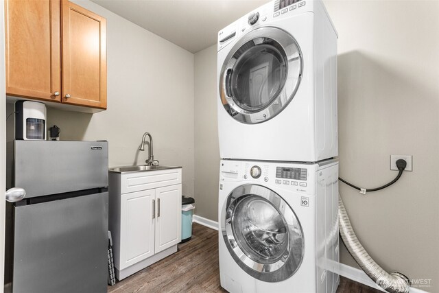 5611 Balustrade Blvd SE, Lacey, WA 98513 - washroom with stacked washer / dryer, cabinet space, and wood finished floors