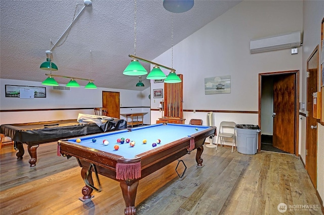 1985 Elhardt St, Camano Island, WA 98282 - playroom featuring a wall mounted air conditioner, billiards table, a textured ceiling, wood finished floors, and vaulted ceiling