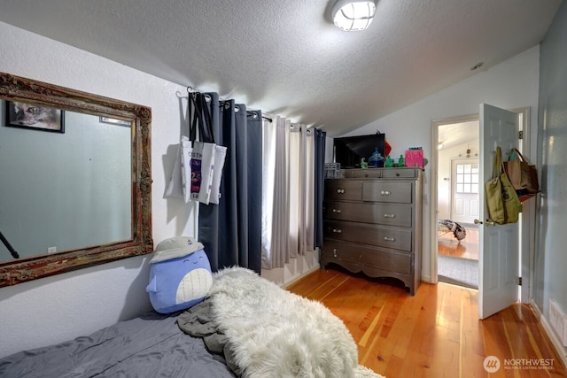 218 SW 15th St, Long Beach, WA 98631 - bedroom with lofted ceiling, a textured ceiling, and light wood finished floors