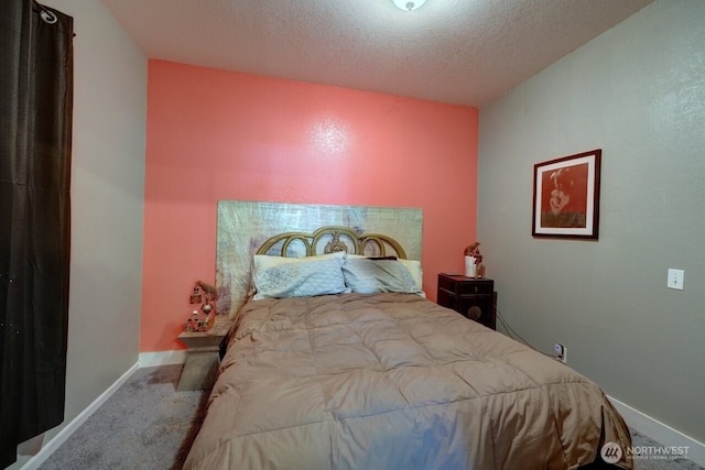 218 SW 15th St, Long Beach, WA 98631 - carpeted bedroom featuring a textured ceiling and baseboards