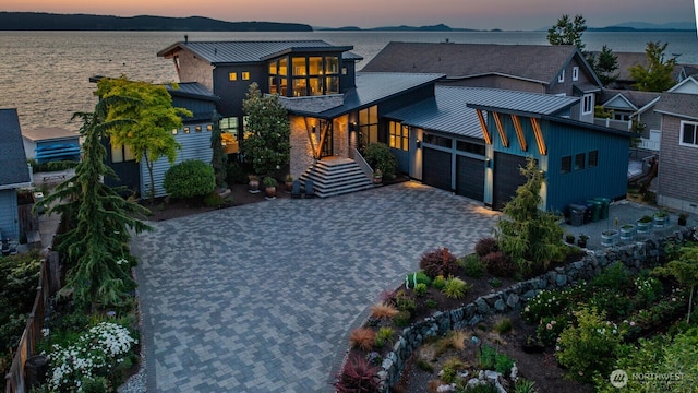 181 Utsalady Rd, Camano Island, WA 98282 - view of front of home featuring a standing seam roof, a metal roof, a garage, and decorative driveway
