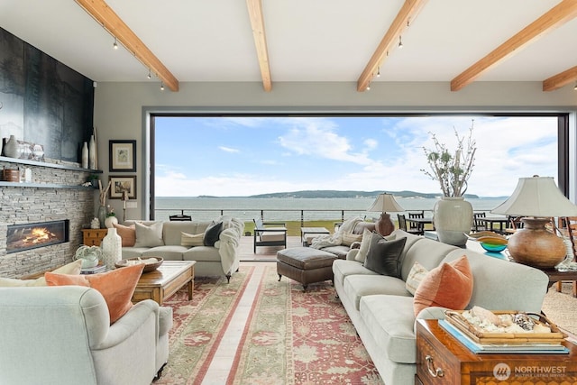 181 Utsalady Rd, Camano Island, WA 98282 - living area with beam ceiling, a fireplace, and a water view