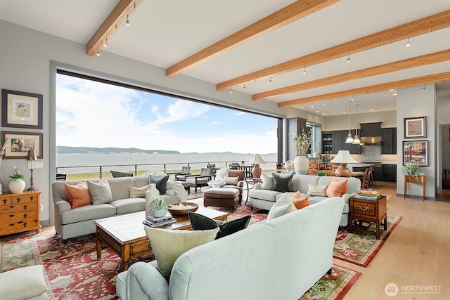 181 Utsalady Rd, Camano Island, WA 98282 - living room featuring beam ceiling, track lighting, a water view, light wood-style floors, and a chandelier