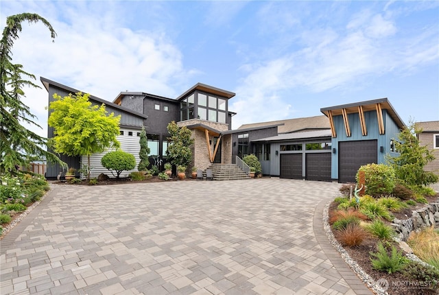 181 Utsalady Rd, Camano Island, WA 98282 - modern home featuring a garage, decorative driveway, and board and batten siding
