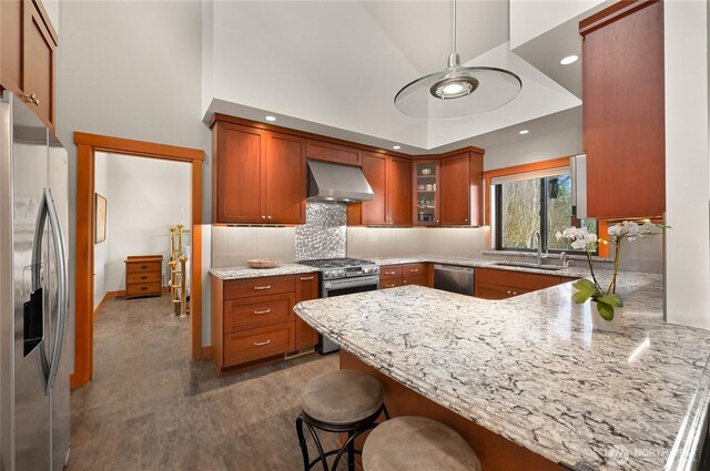 229 Chuckanut Point Rd, Bellingham, WA 98229 - kitchen with ventilation hood, stainless steel appliances, a peninsula, light stone countertops, and backsplash