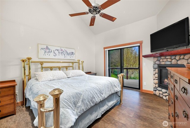 229 Chuckanut Point Rd, Bellingham, WA 98229 - bedroom with access to outside, high vaulted ceiling, a stone fireplace, wood finished floors, and a ceiling fan