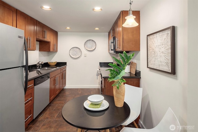 9013 16th Ave SW Unit 11, Seattle, WA 98106 - kitchen with stainless steel appliances, dark countertops, brown cabinets, and recessed lighting