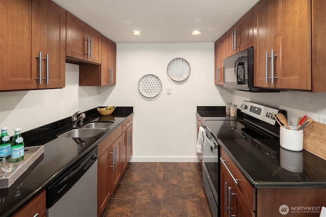 9013 16th Ave SW Unit 11, Seattle, WA 98106 - kitchen featuring stainless steel appliances, recessed lighting, brown cabinetry, and stone finish floors