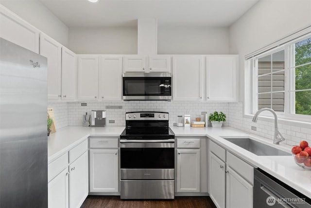 8629 240th St SW Unit B4, Edmonds, WA 98026 - kitchen featuring appliances with stainless steel finishes, white cabinetry, decorative backsplash, and light countertops