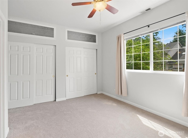 8629 240th St SW Unit B4, Edmonds, WA 98026 - unfurnished bedroom with carpet flooring, multiple windows, a ceiling fan, and a closet