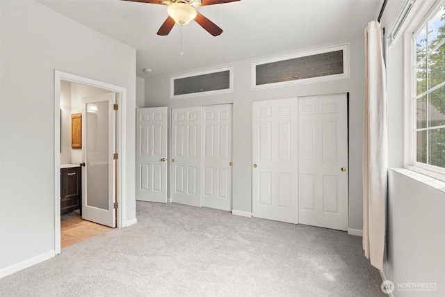 8629 240th St SW Unit B4, Edmonds, WA 98026 - unfurnished bedroom featuring light carpet, multiple closets, multiple windows, and ensuite bath