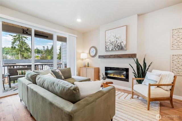 1322 194th St SE Unit H4, Bothell, WA 98012 - living area featuring light wood-style flooring, a glass covered fireplace, and recessed lighting