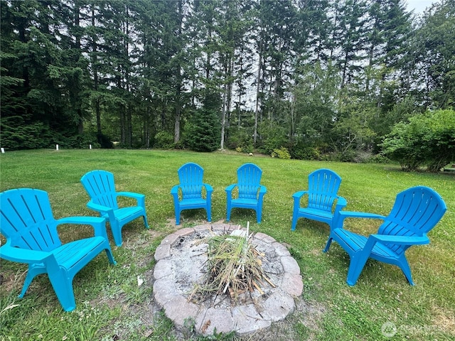 30 E Richardson Rd, Belfair, WA 98528 - view of grassy yard featuring a fire pit