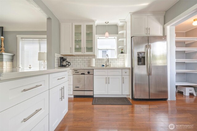 5253 35th Ave SW, Seattle, WA 98126 - kitchen with stainless steel refrigerator with ice dispenser, dishwasher, light countertops, backsplash, and white cabinets