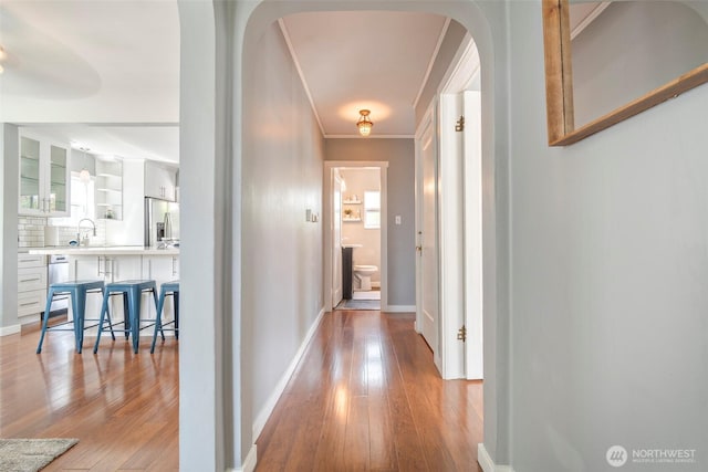 5253 35th Ave SW, Seattle, WA 98126 - corridor featuring light wood-style flooring, arched walkways, and crown molding