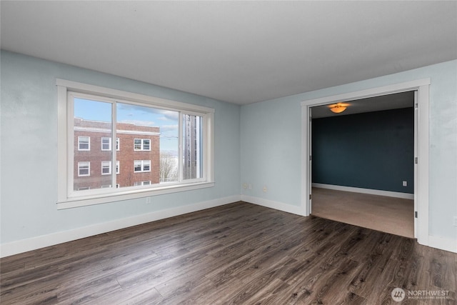25 N Broadway Unit 207, Tacoma, WA 98403 - spare room featuring dark wood-type flooring and baseboards