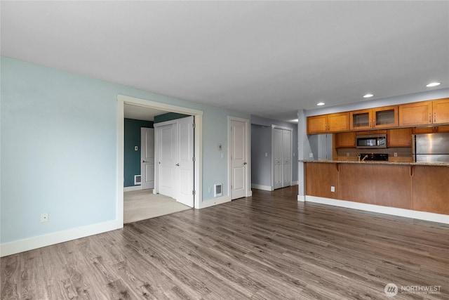 25 N Broadway Unit 207, Tacoma, WA 98403 - unfurnished living room featuring wood finished floors and recessed lighting