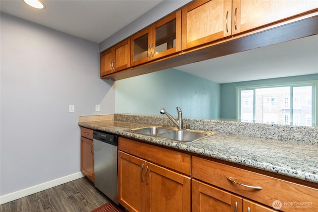 25 N Broadway Unit 207, Tacoma, WA 98403 - kitchen featuring dishwasher, dark wood-style flooring, brown cabinetry, glass insert cabinets, and light stone countertops