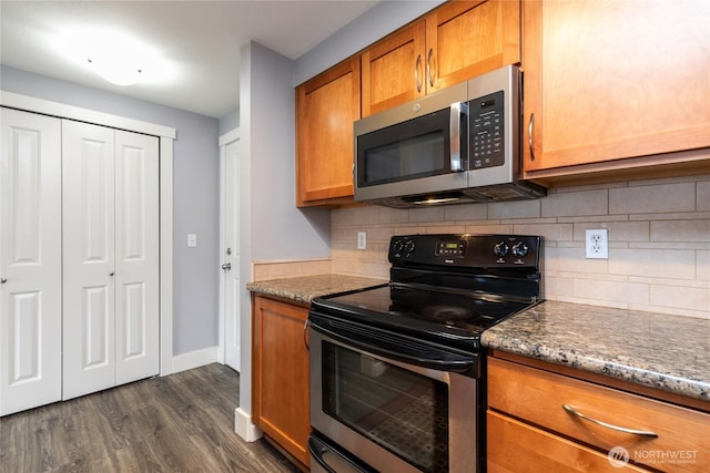 25 N Broadway Unit 207, Tacoma, WA 98403 - kitchen featuring stainless steel microwave, range with electric stovetop, brown cabinets, dark wood-style floors, and decorative backsplash