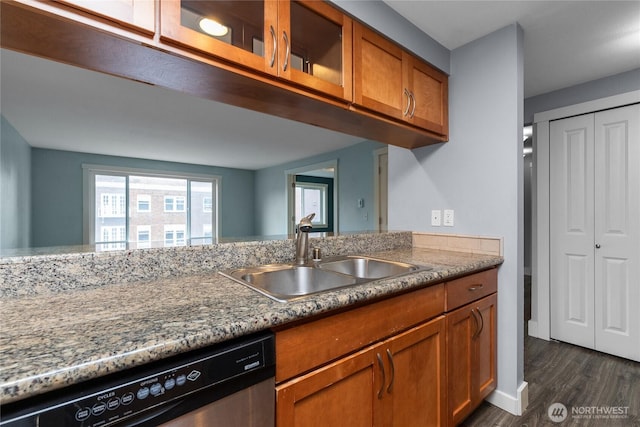 25 N Broadway Unit 207, Tacoma, WA 98403 - kitchen with dishwasher, brown cabinetry, dark wood-type flooring, glass insert cabinets, and light stone counters